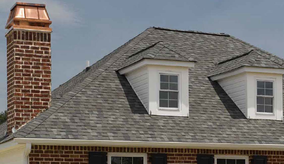 CertainTeed's asphalt shingle installed on a home with 2 dormers and a chimney
