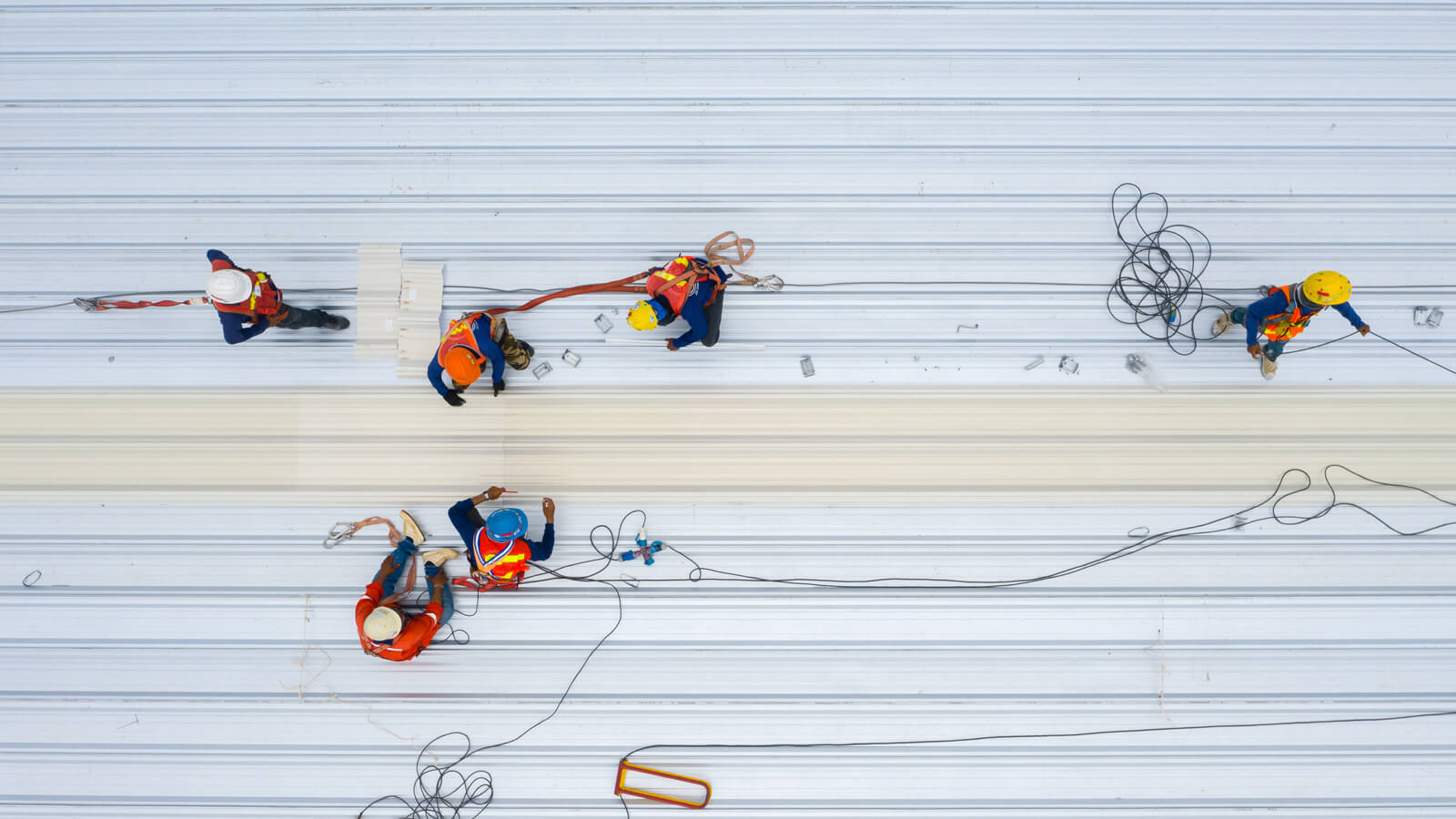 Commercial roofers performing repairs on a roof