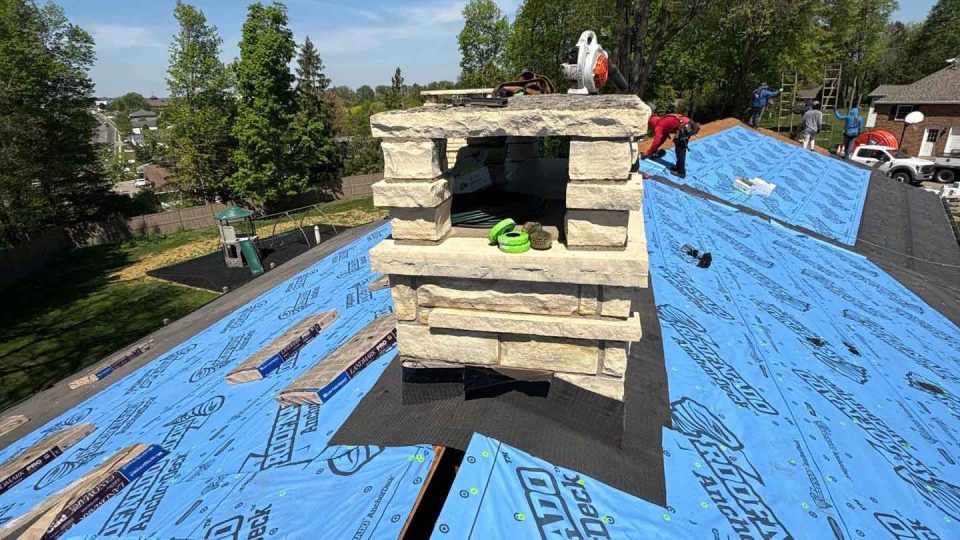Dubuque, IA house #1 during roof replacement installing new underlayment and flashing around chimney