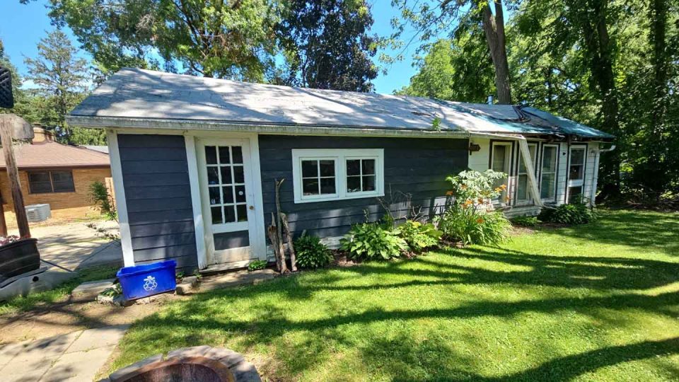 Freeport, IL house #1 before roof replacement showing damaged and missing shingles after a storm