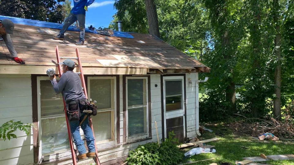 Freeport, IL house #1 during roof replacement as roofers install new plywood over damaged roof