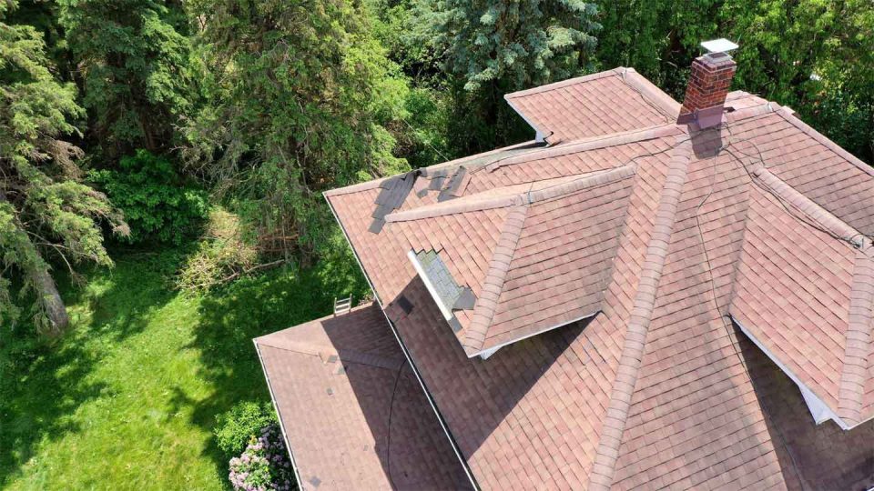 Freeport, IL house #2 before roof replacement showing damaged and missing shingles after a storm