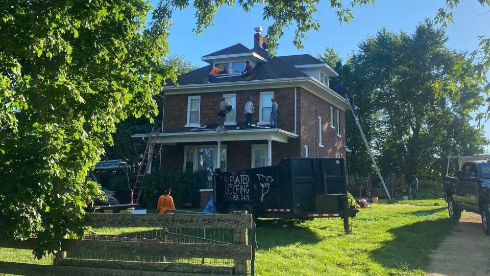 Freeport, IL house #2 during roof replacement showing roofers installing new shingles