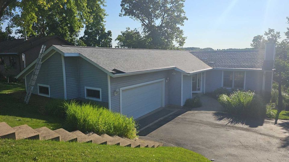 Mount Carroll, IL house #2 before roof replacement showing curled and aging asphalt shingles