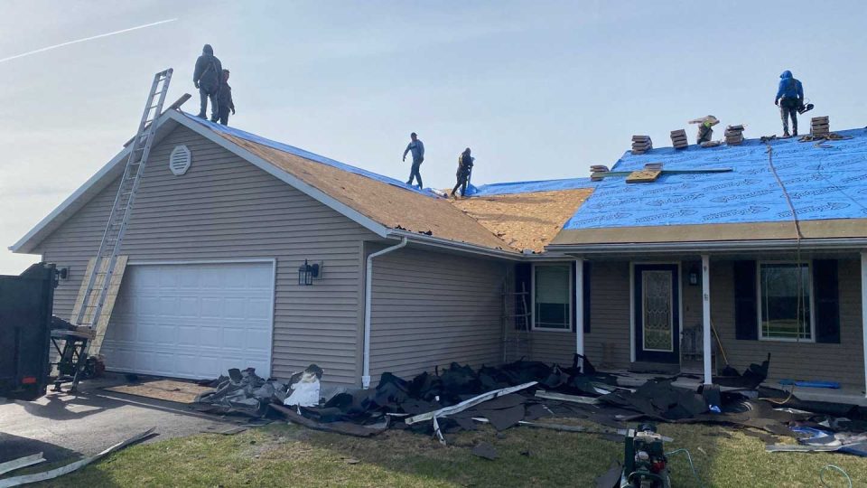 Mount Carroll, IL house #3 during roof replacement as roofers install the underlayment