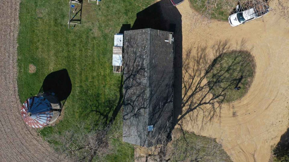 Pearl City, IL barn before full roof replacement showing aging, damaged, and missing shingles
