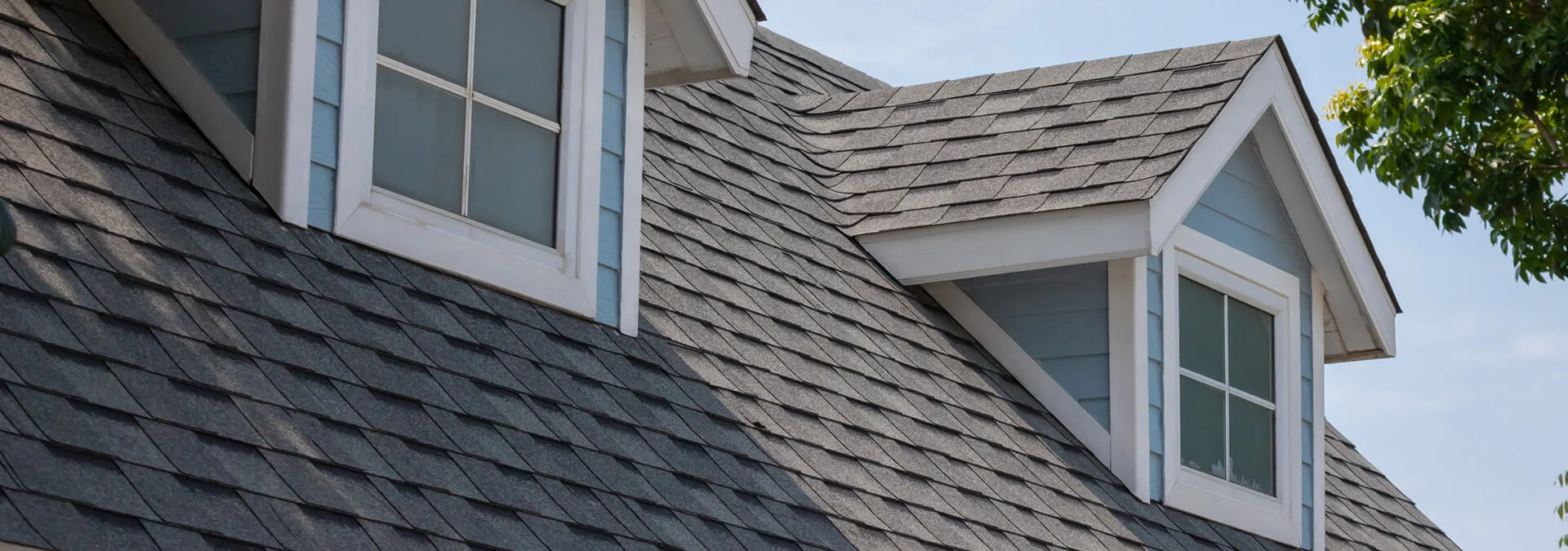 Close up of a rooftop with 2 dormers