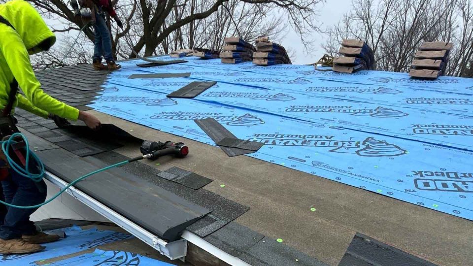 Stockton, IL single level ranch home #1 during a full roof replacement with roofers installing new asphalt shingles