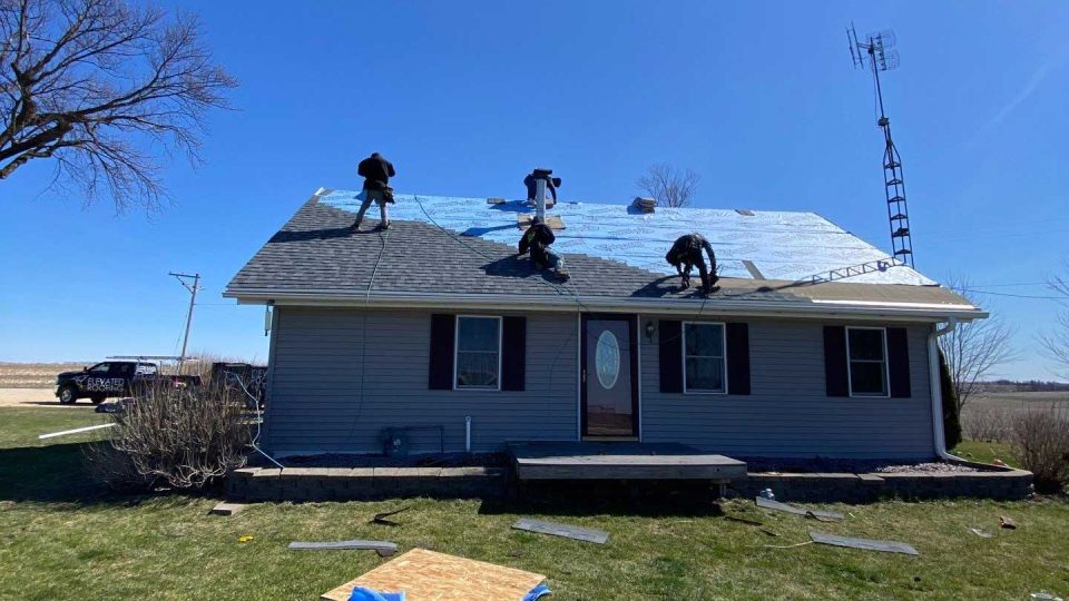 Warren, IL house #1 during roof replacement installing asphalt shingles over the underlayment